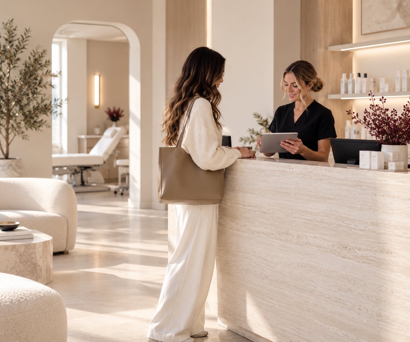 A client checking in at a med spa front desk while a team member looks up her appointment on a tablet